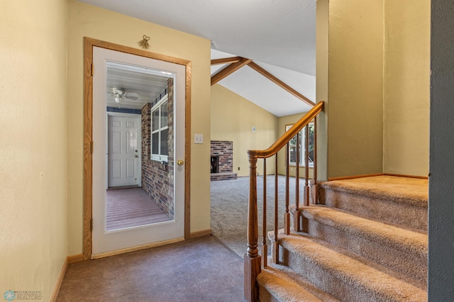 stairway featuring carpet, lofted ceiling, and baseboards