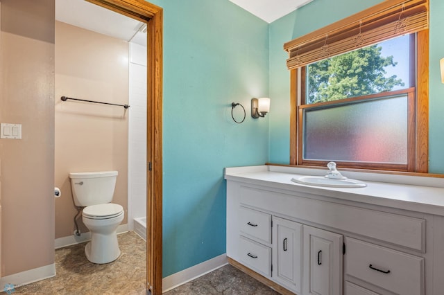 full bath with toilet, vanity, baseboards, and a shower