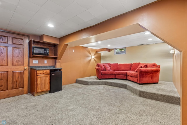 living room with light colored carpet, recessed lighting, and bar area