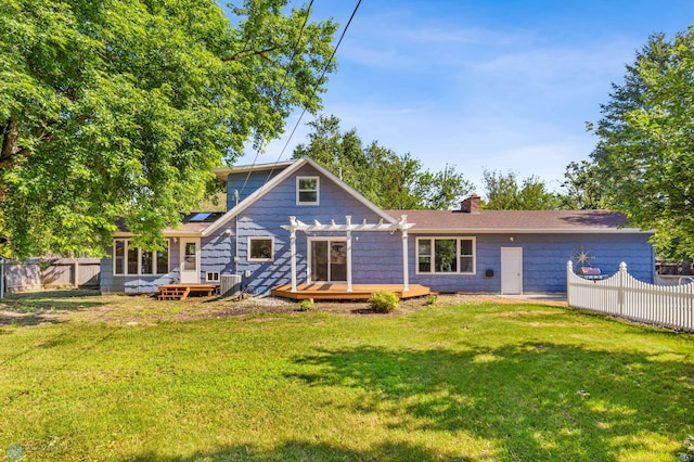 rear view of property with a pergola, a wooden deck, a chimney, cooling unit, and solar panels