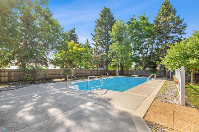 view of pool with a patio and a fenced backyard