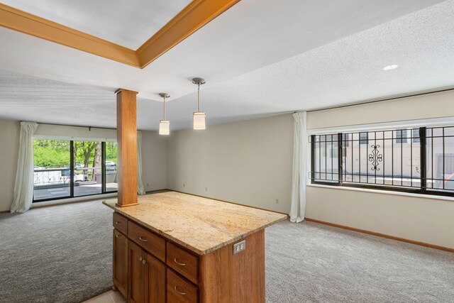 2885 Knox Ave S Unit 208, Minneapolis, MN 55408 - kitchen featuring light colored carpet, open floor plan, decorative columns, and brown cabinetry