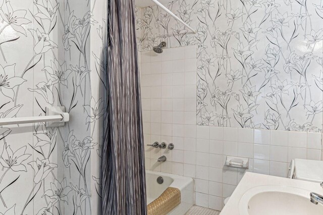 4860 Park Commons Dr Unit 309, Saint Louis Park, MN 55416 - full bathroom featuring a sink, shower / bath combo with shower curtain, and tile walls