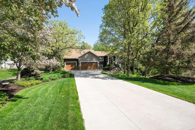 ranch-style home featuring concrete driveway, a garage, and a front lawn