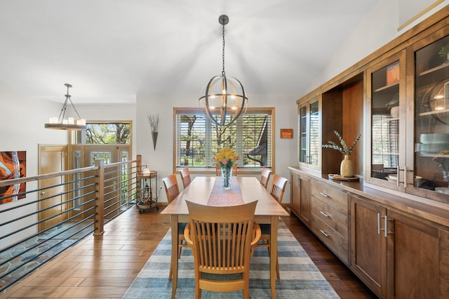 dining room featuring a chandelier and dark wood-style floors