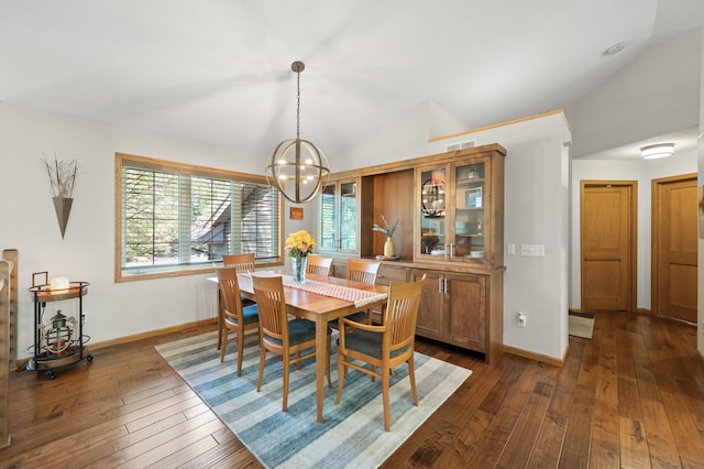 dining room with dark wood finished floors, vaulted ceiling, a chandelier, and baseboards