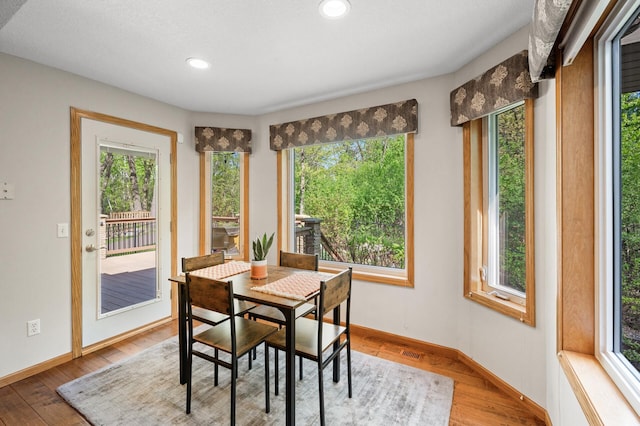 dining area with plenty of natural light, wood finished floors, baseboards, and recessed lighting