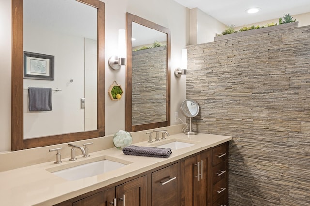 bathroom with double vanity and recessed lighting