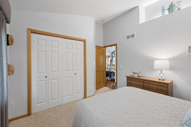 bedroom featuring carpet flooring, a closet, baseboards, and vaulted ceiling