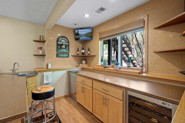 indoor bar with wine cooler, light wood-style flooring, and recessed lighting