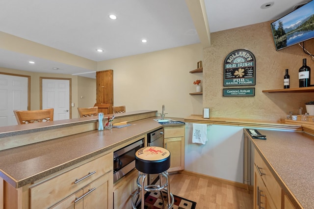 kitchen featuring stainless steel microwave, open shelves, light brown cabinets, light wood finished floors, and recessed lighting