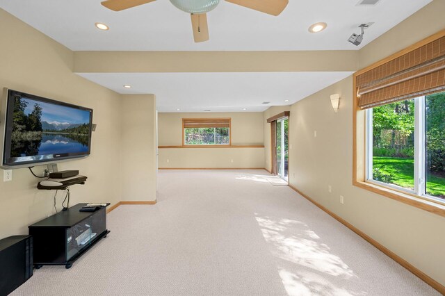 unfurnished living room with plenty of natural light, baseboards, ceiling fan, carpet, and recessed lighting