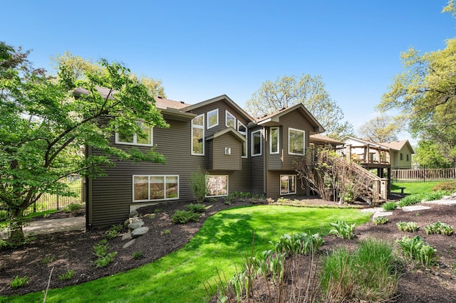 rear view of house featuring stairs and a wooden deck