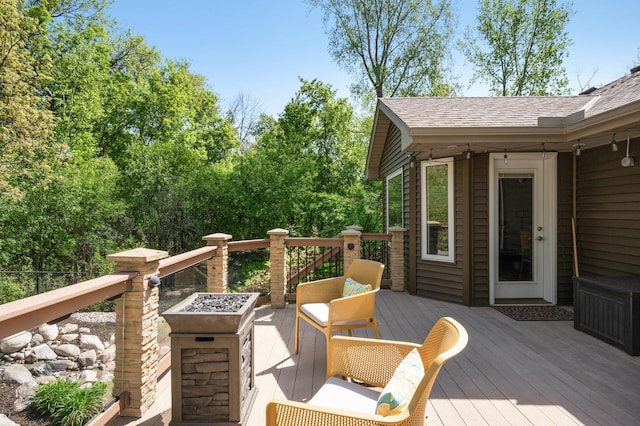 wooden terrace featuring an outdoor fire pit
