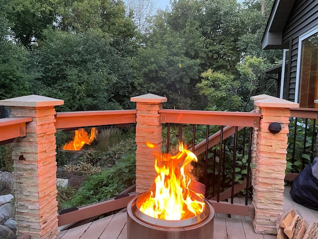 gate with a fire pit and a deck