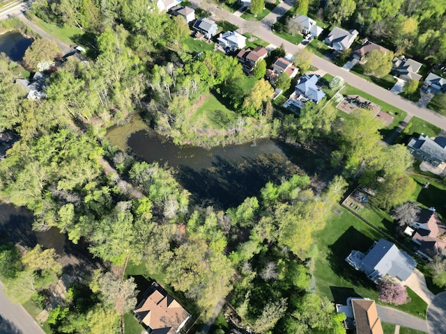 aerial view of property's location with nearby suburban area and a large body of water