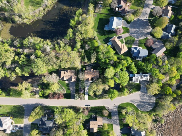 aerial view of property and surrounding area featuring nearby suburban area
