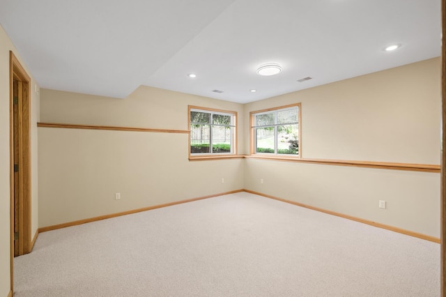 spare room featuring carpet flooring, baseboards, and recessed lighting