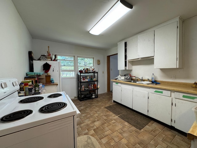 3545 White Birch Ave NE, Bemidji, MN 56601 - kitchen with white electric stove, a sink, white cabinetry, light countertops, and stone finish floors