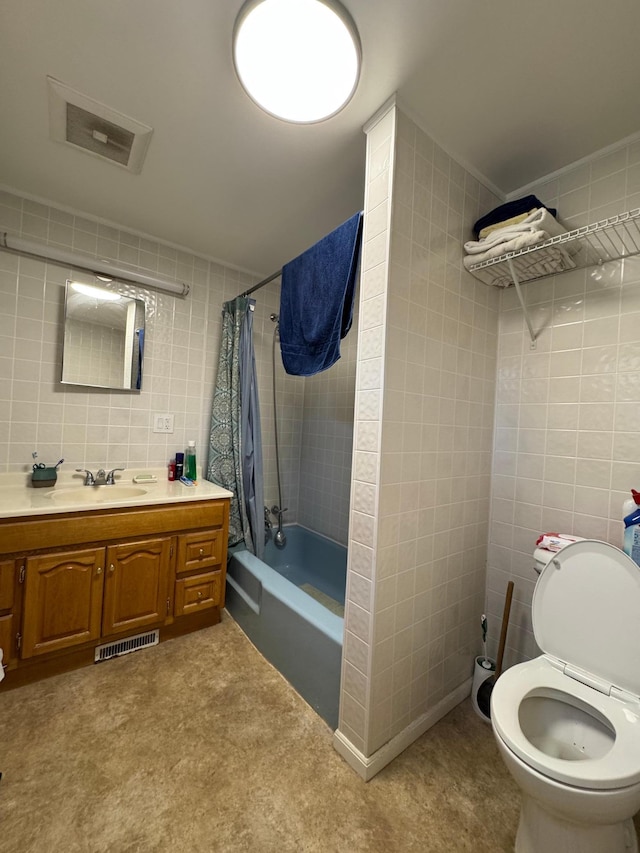 3545 White Birch Ave NE, Bemidji, MN 56601 - bathroom with tile walls, shower / tub combo with curtain, vanity, and toilet