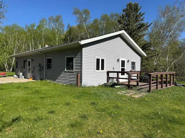 3545 White Birch Ave NE, Bemidji, MN 56601 - view of home's exterior with a yard and a wooden deck