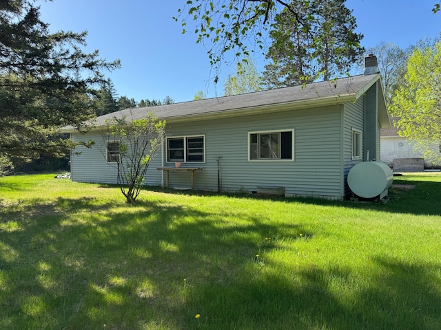 3545 White Birch Ave NE, Bemidji, MN 56601 - rear view of property featuring oil tank, a chimney, and a yard