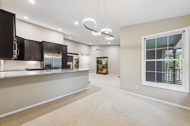 10911 Rhode Island Ave S, Bloomington, MN 55438 - kitchen with stainless steel refrigerator with ice dispenser, light carpet, recessed lighting, light stone countertops, and pendant lighting