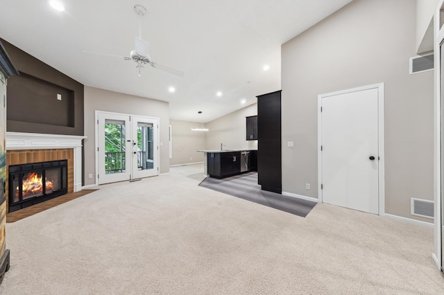 10911 Rhode Island Ave S, Bloomington, MN 55438 - unfurnished living room featuring light colored carpet, a ceiling fan, baseboards, vaulted ceiling, and a fireplace with flush hearth