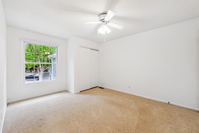 10911 Rhode Island Ave S, Bloomington, MN 55438 - empty room featuring light colored carpet, baseboards, and a ceiling fan