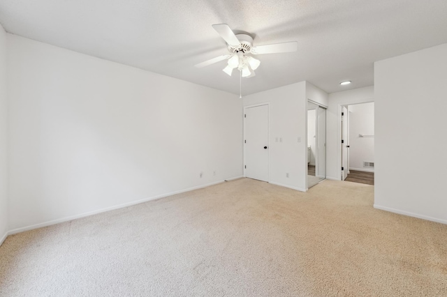 10911 Rhode Island Ave S, Bloomington, MN 55438 - unfurnished bedroom with light carpet, baseboards, a ceiling fan, ensuite bathroom, and multiple closets