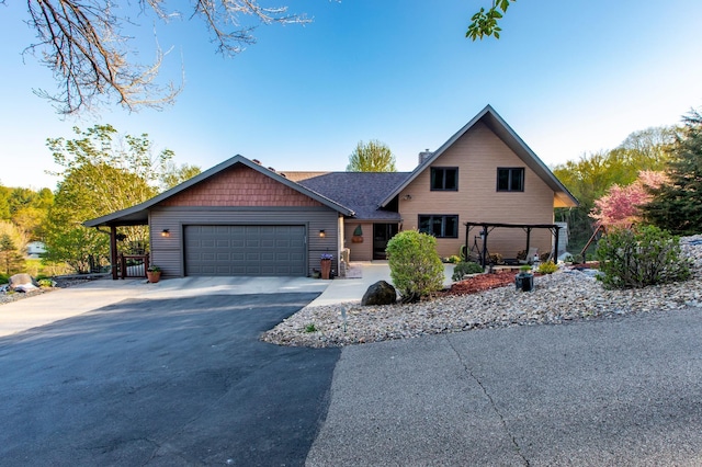 6385 13th Ave NW, Rochester, MN 55901 - chalet / cabin with driveway, an attached garage, and a chimney