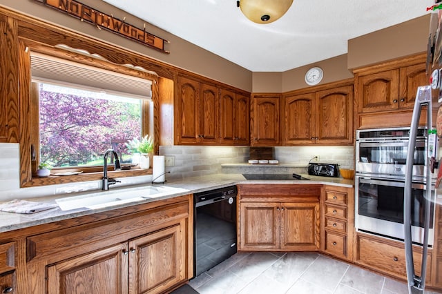 6385 13th Ave NW, Rochester, MN 55901 - kitchen with black appliances, a sink, brown cabinetry, and decorative backsplash