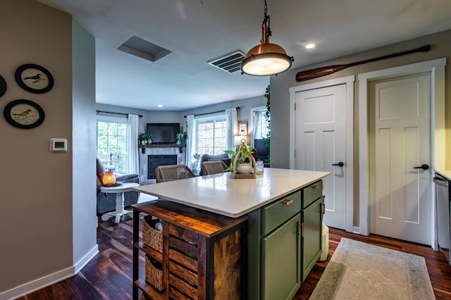 6385 13th Ave NW, Rochester, MN 55901 - kitchen with green cabinetry, dark wood-style flooring, a tile fireplace, baseboards, and light countertops