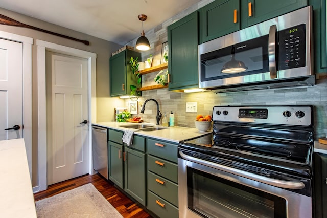 6385 13th Ave NW, Rochester, MN 55901 - kitchen with green cabinets, appliances with stainless steel finishes, a sink, light countertops, and dark wood-type flooring
