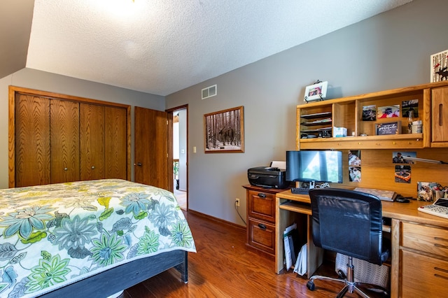 6385 13th Ave NW, Rochester, MN 55901 - bedroom with wood finished floors, baseboards, a closet, and a textured ceiling