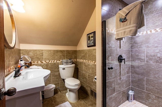 6385 13th Ave NW, Rochester, MN 55901 - bathroom with vanity, a stall shower, vaulted ceiling, toilet, and tile patterned flooring