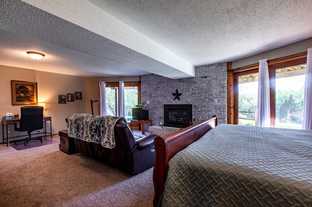 6385 13th Ave NW, Rochester, MN 55901 - bedroom featuring a textured ceiling, a fireplace, access to exterior, carpet flooring, and an office area