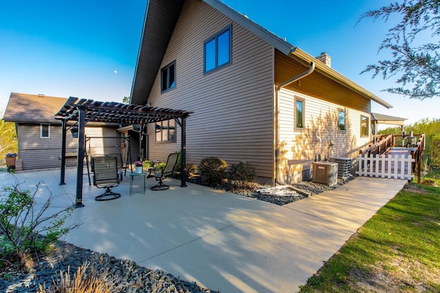 6385 13th Ave NW, Rochester, MN 55901 - rear view of property featuring a pergola, a patio, a chimney, and central AC unit