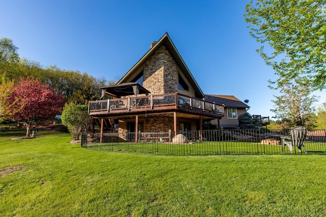 6385 13th Ave NW, Rochester, MN 55901 - rear view of house with a deck, stone siding, and a chimney