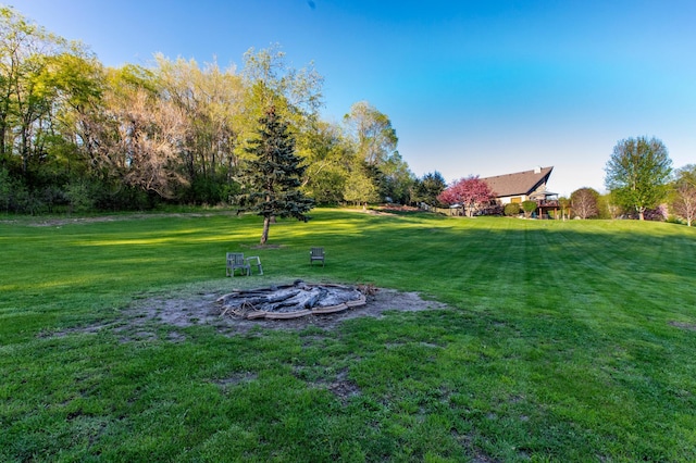 6385 13th Ave NW, Rochester, MN 55901 - view of green lawn with an outdoor fire pit