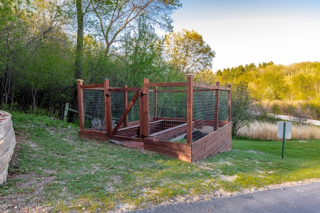 6385 13th Ave NW, Rochester, MN 55901 - gate featuring a yard, a garden, and a view of trees