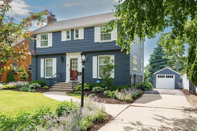 623 Fairview Ave S, Saint Paul, MN 55116 - colonial house with driveway, a detached garage, a chimney, an outbuilding, and a front yard