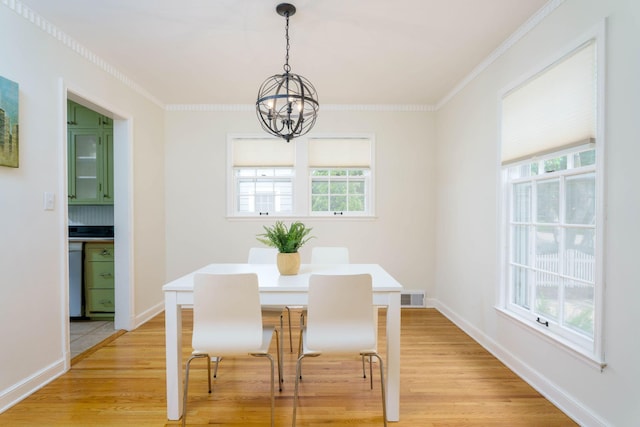 623 Fairview Ave S, Saint Paul, MN 55116 - dining area featuring a chandelier, plenty of natural light, light wood-type flooring, and crown molding