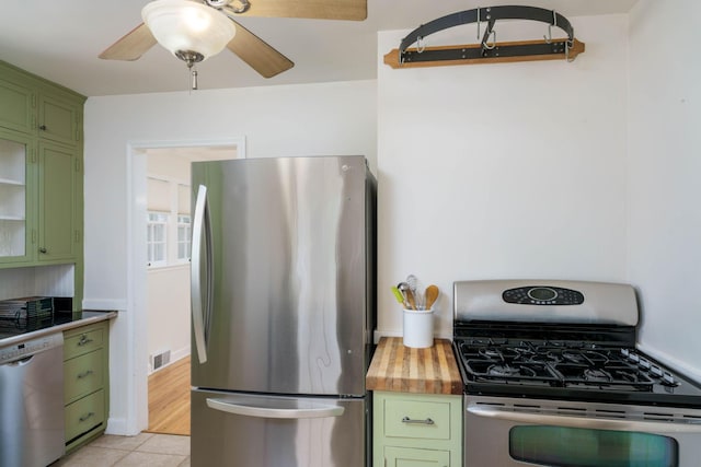 623 Fairview Ave S, Saint Paul, MN 55116 - kitchen featuring green cabinets, appliances with stainless steel finishes, ceiling fan, light tile patterned flooring, and wooden counters