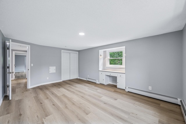 4824 Eriks Blvd, Eagan, MN 55122 - unfurnished bedroom featuring a baseboard heating unit, light wood-type flooring, baseboards, a closet, and recessed lighting