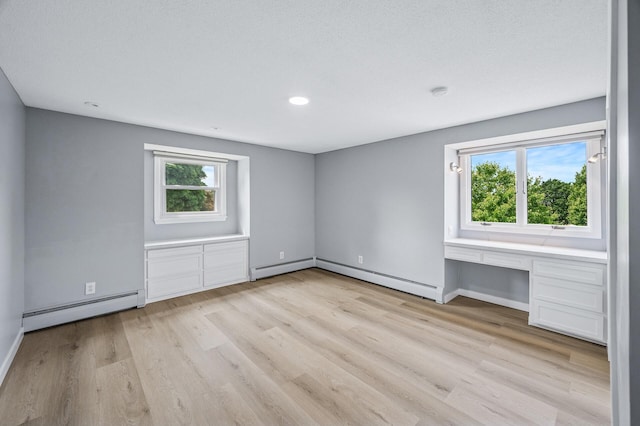 4824 Eriks Blvd, Eagan, MN 55122 - unfurnished room featuring a baseboard radiator, light wood finished floors, plenty of natural light, and recessed lighting