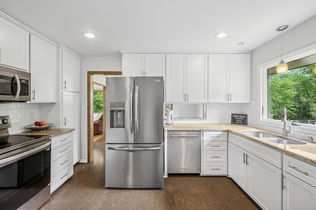 4824 Eriks Blvd, Eagan, MN 55122 - kitchen with appliances with stainless steel finishes, a sink, healthy amount of natural light, white cabinetry, and recessed lighting