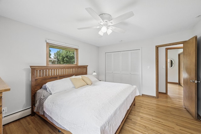 4824 Eriks Blvd, Eagan, MN 55122 - bedroom featuring a baseboard heating unit, light wood finished floors, a closet, baseboards, and a ceiling fan
