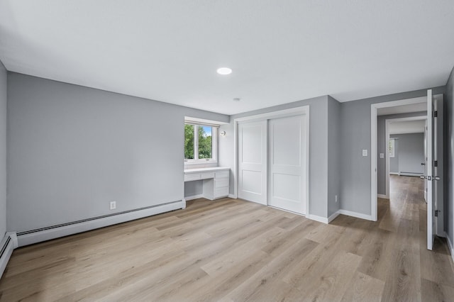 4824 Eriks Blvd, Eagan, MN 55122 - unfurnished bedroom featuring light wood-style flooring, a closet, baseboard heating, baseboards, and a baseboard radiator