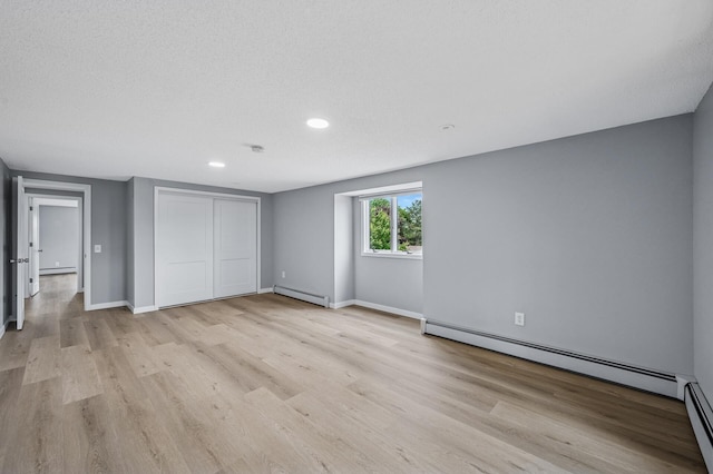 4824 Eriks Blvd, Eagan, MN 55122 - unfurnished bedroom with a baseboard radiator, baseboard heating, light wood finished floors, recessed lighting, and baseboards